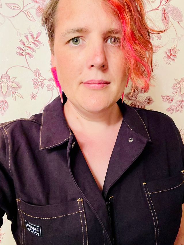 Selfie with neon pink lightning earrings and a black jumpsuit